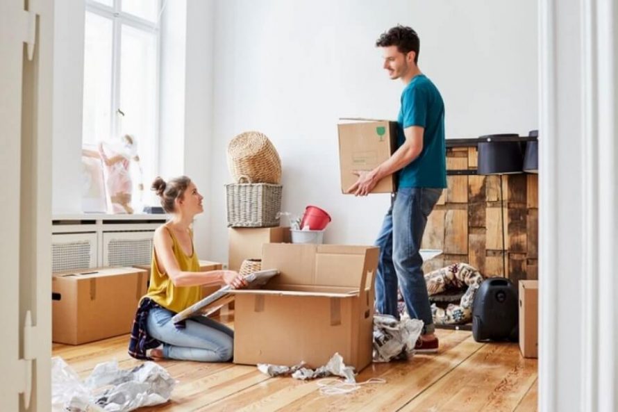 New Home couple packing in cardboard box